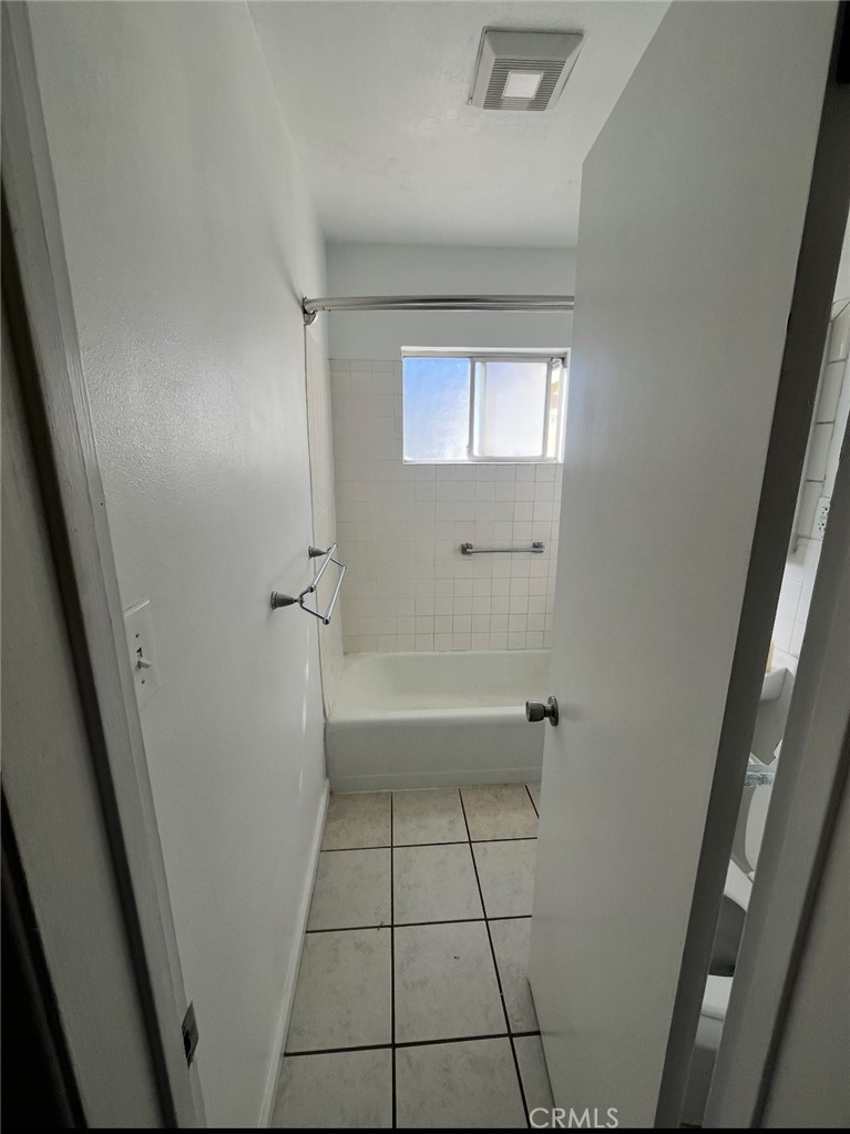 4136 Eileen Street Riverside, CA 92504 - Photo 6 of 13 a bathroom with a sink a toilet and shower