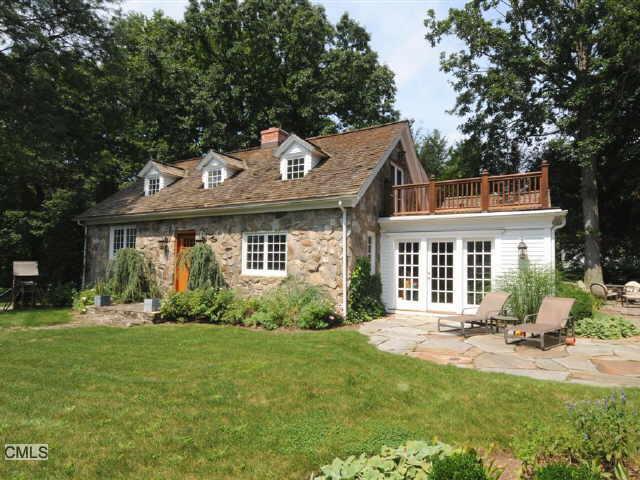 157 Hillspoint Road Westport, CT 06880 - Photo 1 of 1 a front view of a house with a yard table and chairs