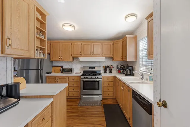 a kitchen with a sink a stove top oven and cabinets