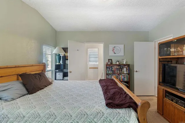 a bedroom with a bed and a television