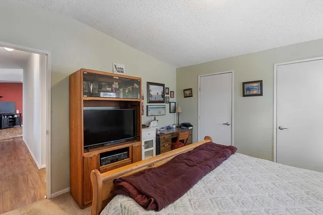 a bedroom with furniture and flat screen tv