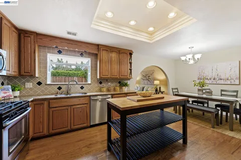 a backyard of a house with barbeque oven table and chairs