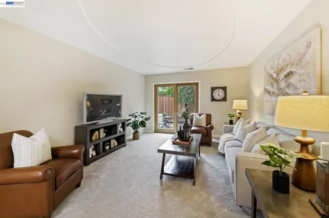a view of a chairs and table in patio with a fire pit