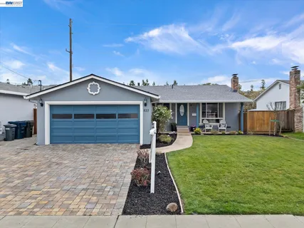 a living room with fireplace furniture and a large window