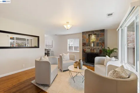 a view of a dining room with furniture a chandelier and wooden floor