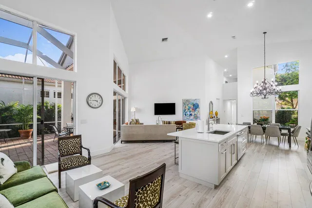 a living room with furniture kitchen view and a window
