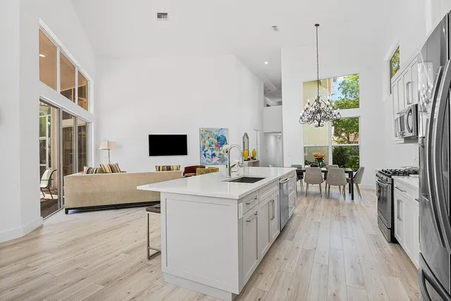 a view of a dining room with furniture a chandelier and wooden floor