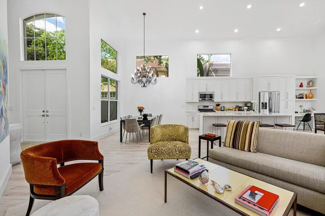 a dining room with furniture a large window and wooden floor