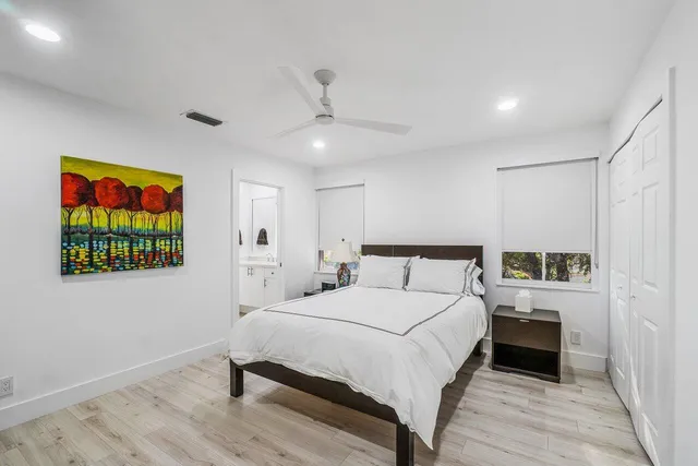 a bedroom with a bed and a painting on the wall