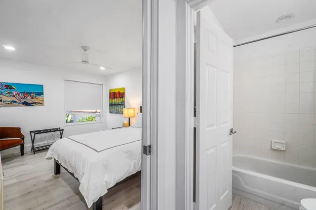 a bedroom with a bed and a painting on the wall