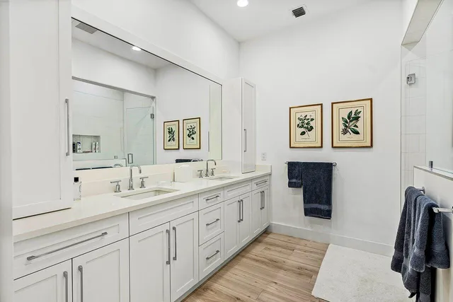 a bathroom with a double vanity sink and a mirror