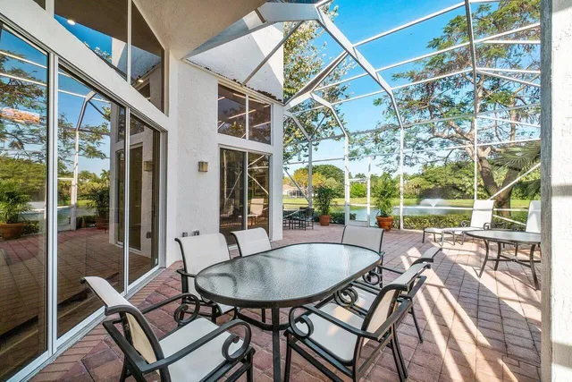 a view of house with backyard and sitting area