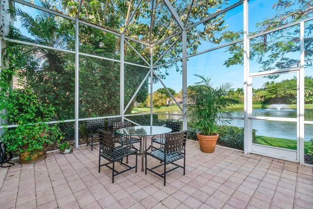 a view of a patio with table and chairs under an umbrella