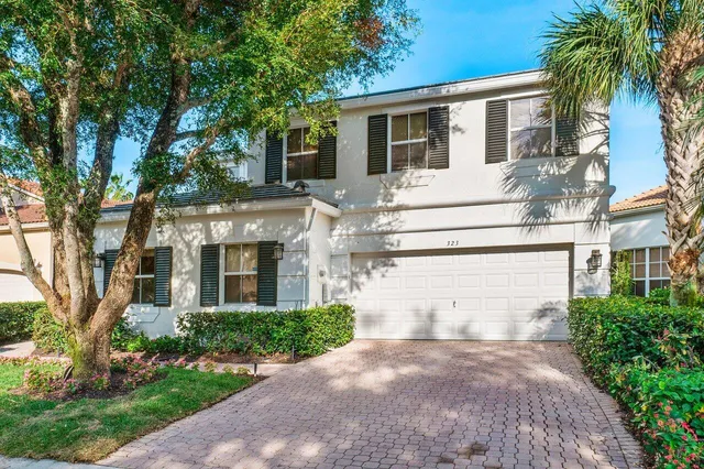 a front view of multiple houses with yard