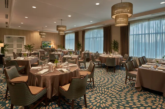 a front view of building with play ground and trees