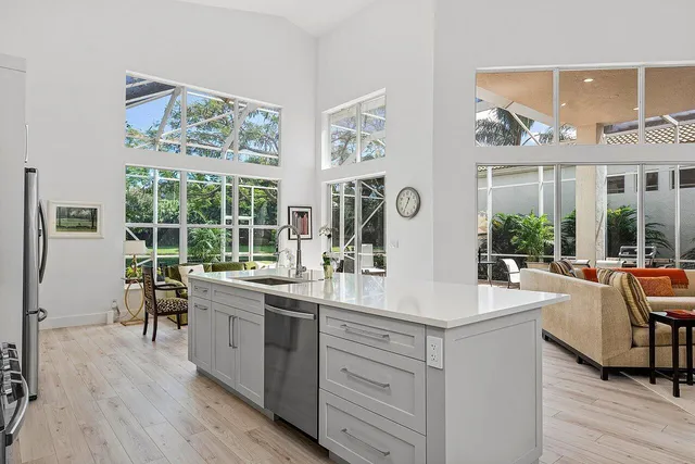 a dining room filled chandelier and wooden floor