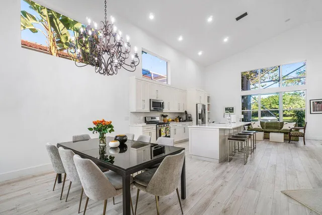 a living room with furniture and a dining table with kitchen view