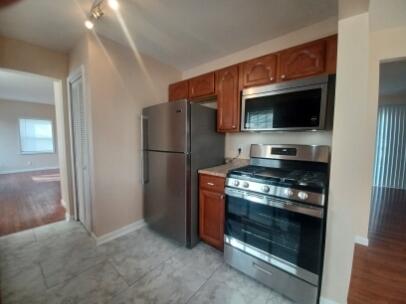 412 West South Street Crown Point, IN 46307 - Photo 4 of 12 a kitchen with a refrigerator stove and microwave