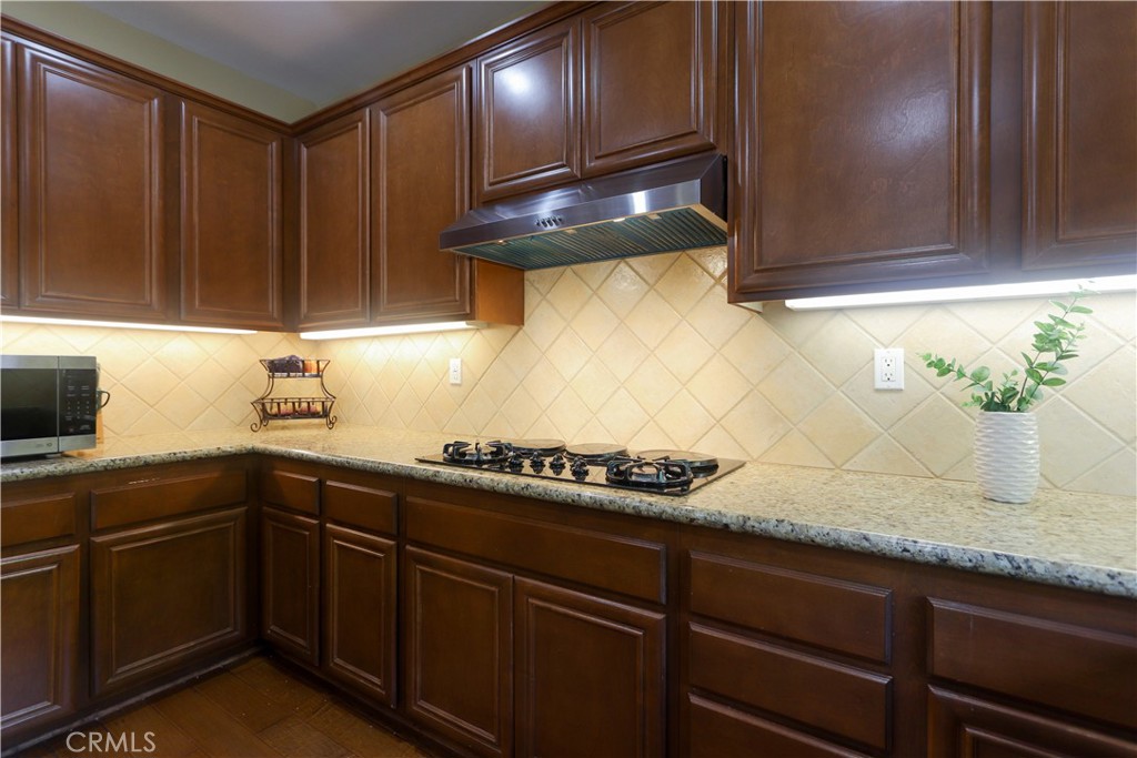 321 Tomko Way Placentia, CA 92870 - Photo 19 of 52 a kitchen with granite countertop stainless steel appliances a sink stove and cabinets