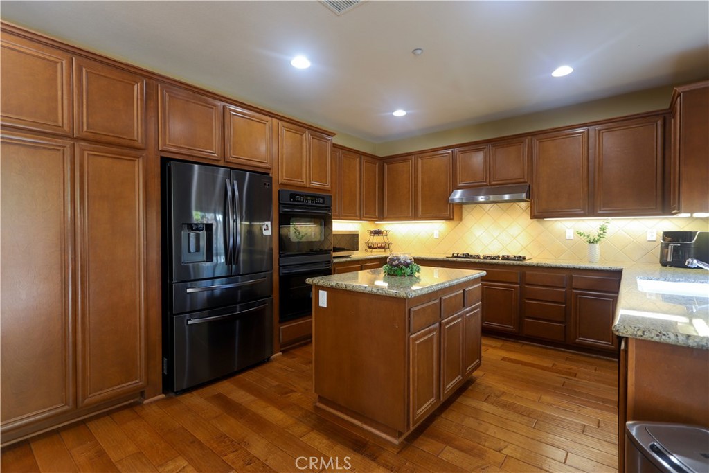 321 Tomko Way Placentia, CA 92870 - Photo 20 of 52 a kitchen with stainless steel appliances granite countertop a stove a refrigerator and a sink