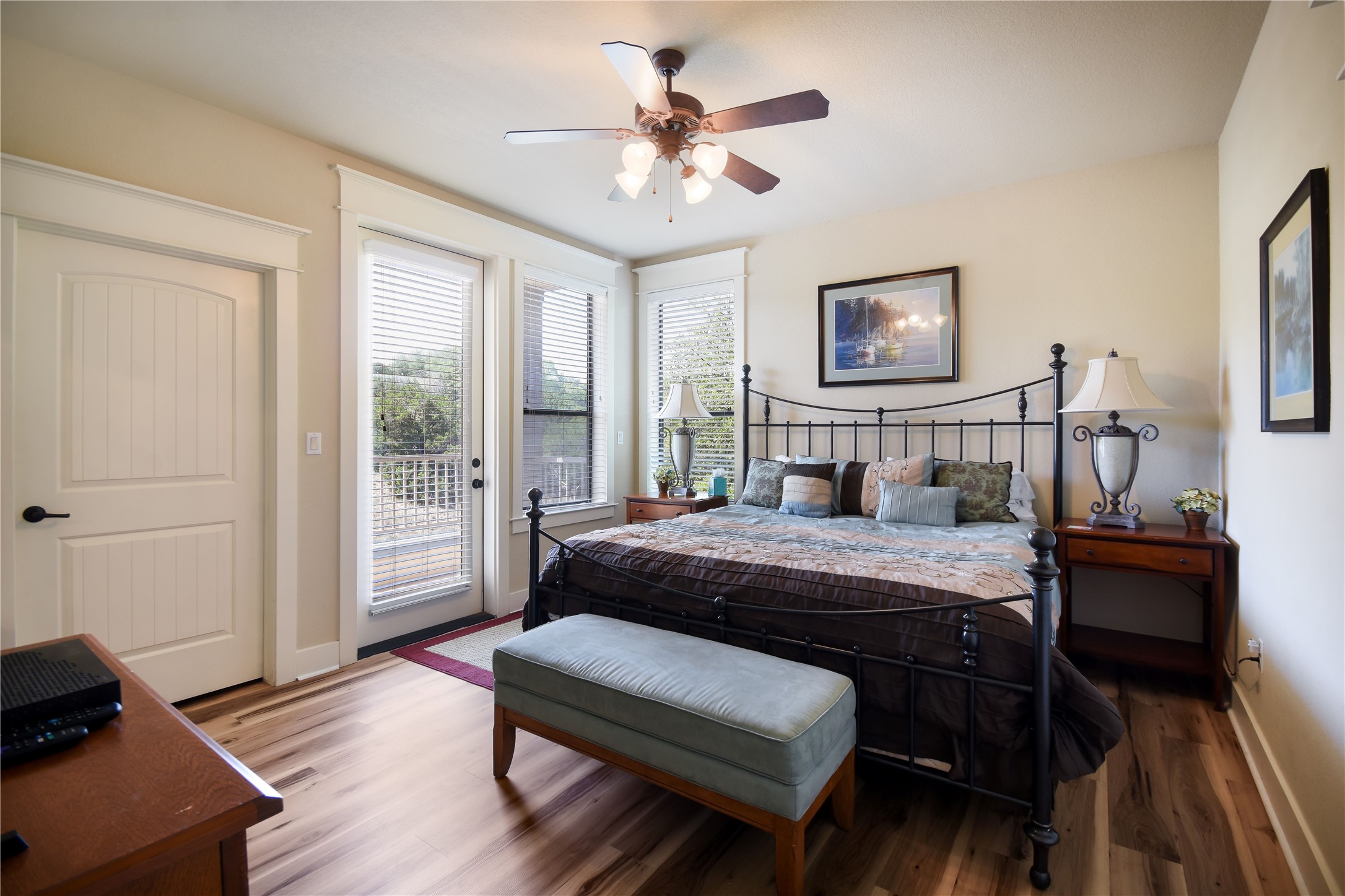 17800 Edgewood Way, Unit 203 Jonestown, TX 78645 - Photo 12 of 40 a bedroom with a bed and a chandelier