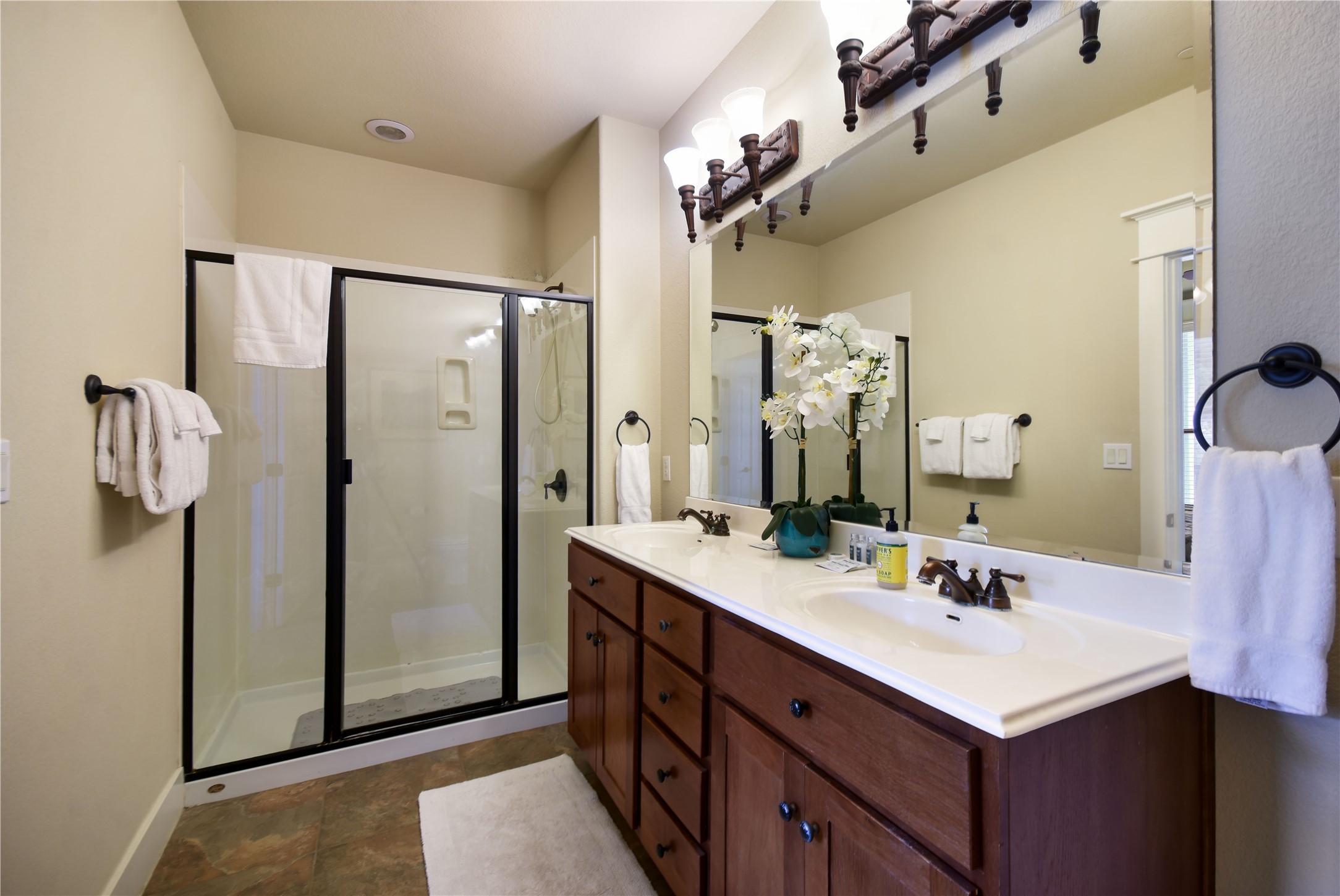 17800 Edgewood Way, Unit 203 Jonestown, TX 78645 - Photo 14 of 40 a bathroom with a sink vanity and a mirror