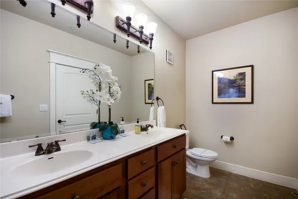 a bathroom with a toilet sink and mirror