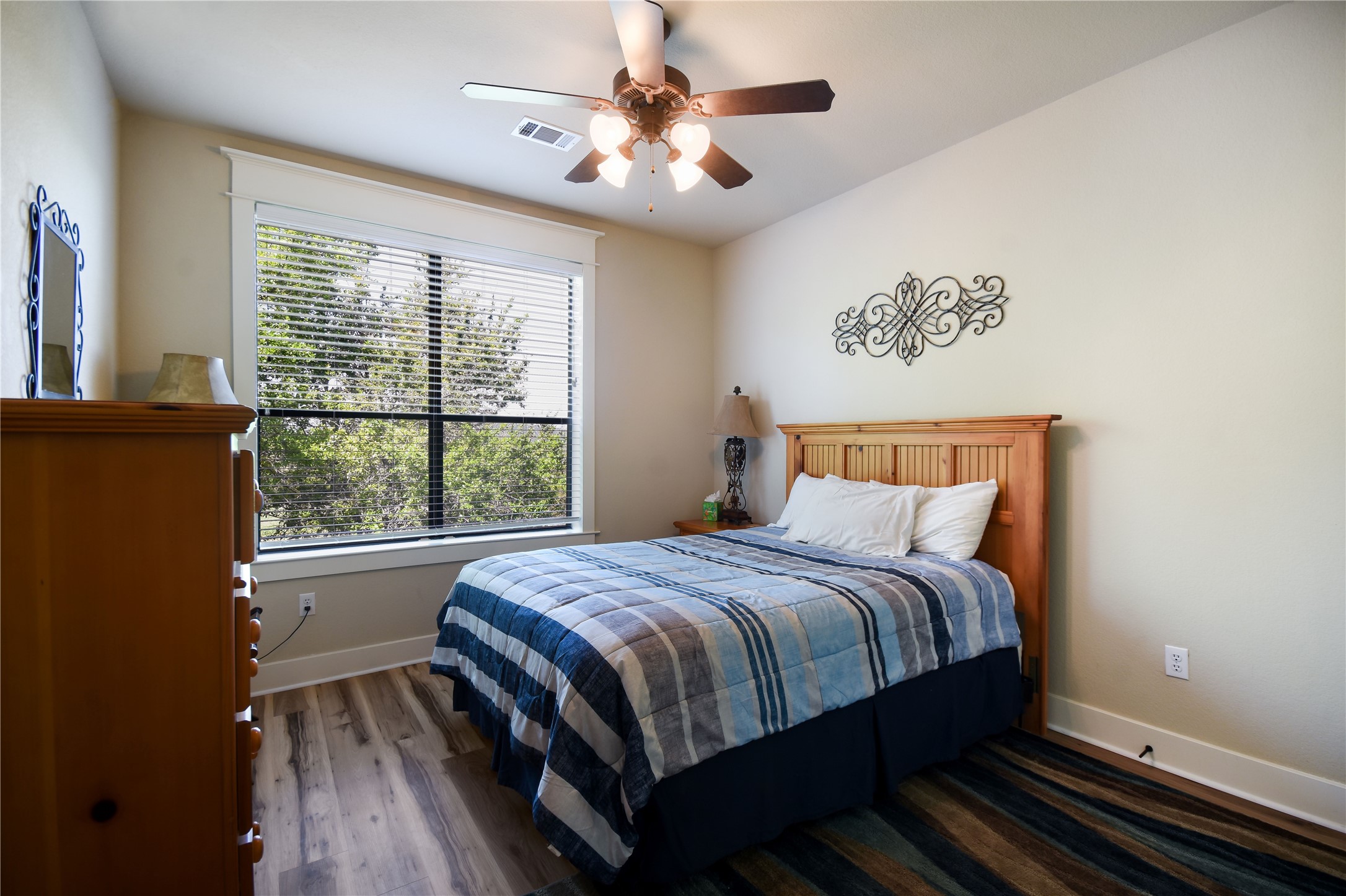 17800 Edgewood Way, Unit 203 Jonestown, TX 78645 - Photo 17 of 40 a bedroom with a large bed and a window