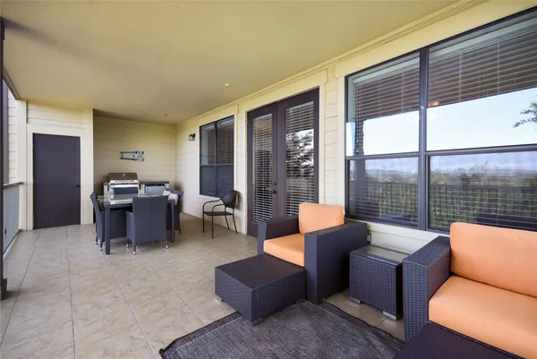 a living room with furniture and large windows