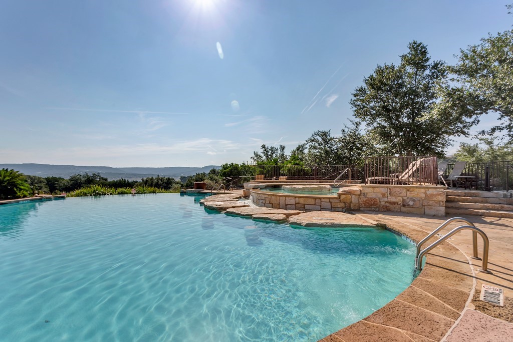 17800 Edgewood Way, Unit 203 Jonestown, TX 78645 - Photo 27 of 40 a view of swimming pool with outdoor seating and lake