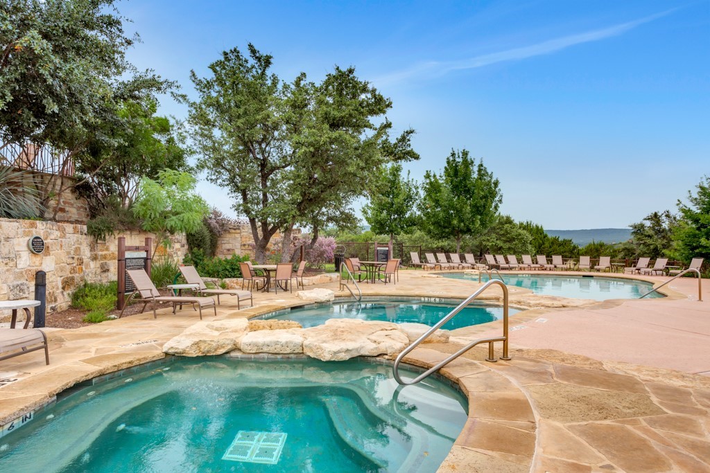 17800 Edgewood Way, Unit 203 Jonestown, TX 78645 - Photo 28 of 40 a view of a swimming pool with a patio