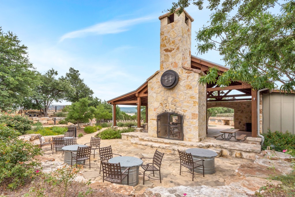 17800 Edgewood Way, Unit 203 Jonestown, TX 78645 - Photo 31 of 40 a view of a chairs and tables in the patio