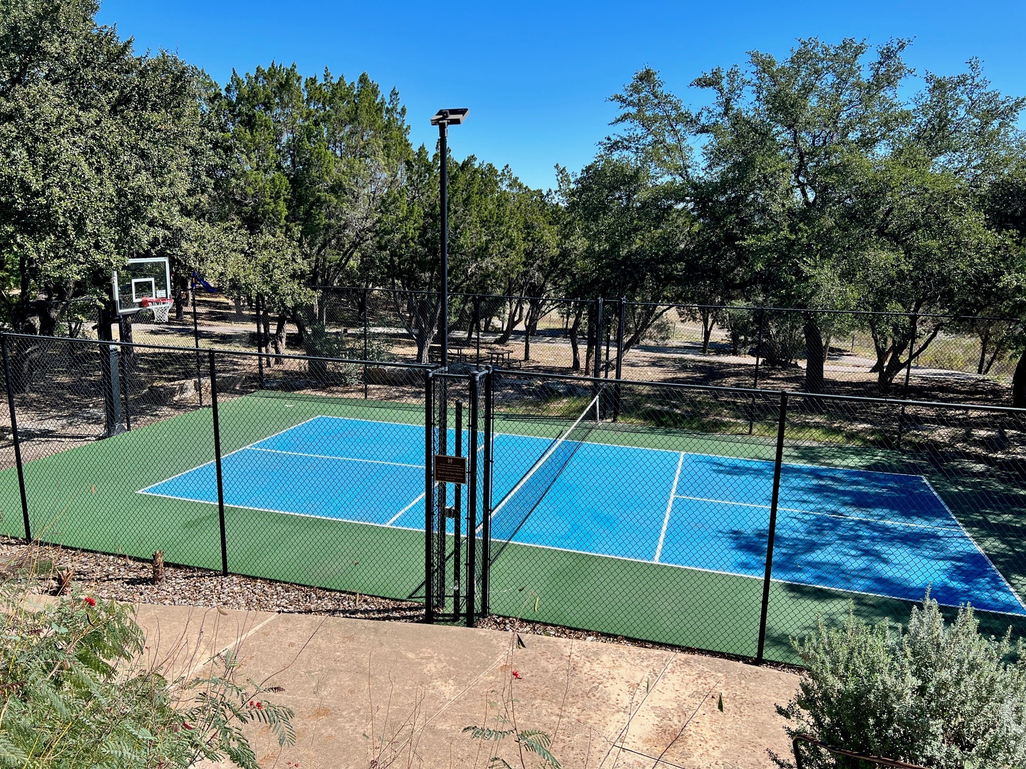 17800 Edgewood Way, Unit 203 Jonestown, TX 78645 - Photo 32 of 40 a view of a park with potted plants