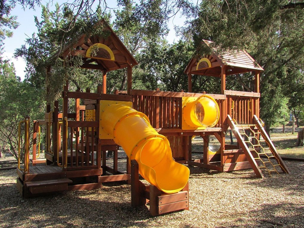 17800 Edgewood Way, Unit 203 Jonestown, TX 78645 - Photo 33 of 40 a view of a park with slide and a slide