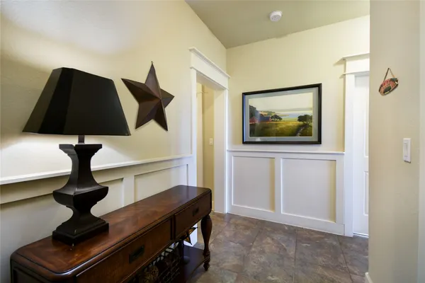 a kitchen with stainless steel appliances granite countertop a stove top oven a sink dishwasher a dining table and chairs