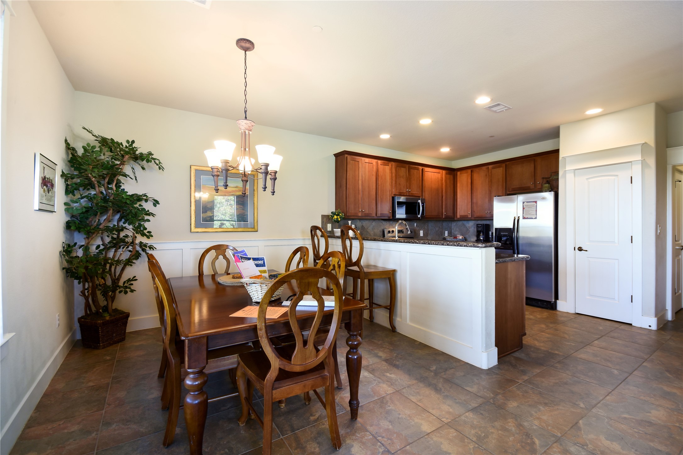 17800 Edgewood Way, Unit 203 Jonestown, TX 78645 - Photo 8 of 40 a view of a dining room and kitchen with a table chairs