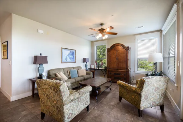 a living room with furniture fireplace and a large window