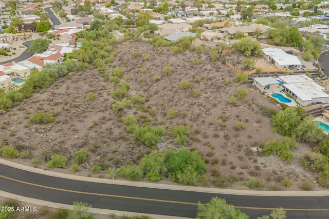 an aerial view of a house with a mountain