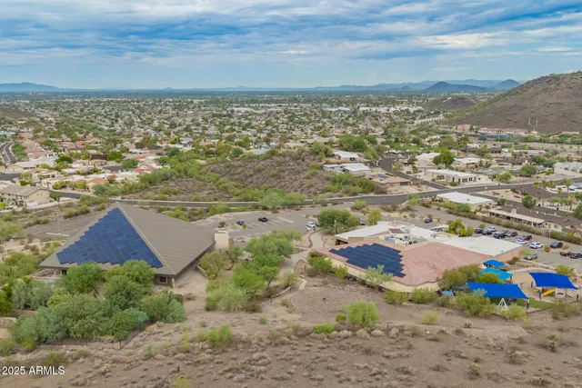 a view of a dry yard with mountains in the background