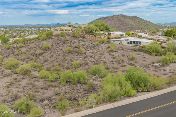 a view of a outdoor space with green field and mountains
