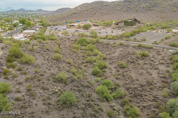 a view of a field with trees in the background