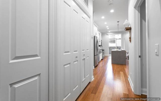 Undisclosed Address Chicago, IL 60607 - Photo 2 of 10 a view of a hallway with wooden floor and a bathroom