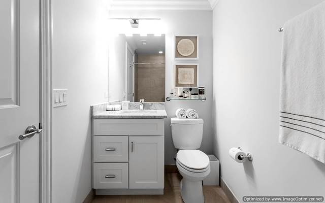 Undisclosed Address Chicago, IL 60607 - Photo 7 of 10 a bathroom with a toilet sink and mirror