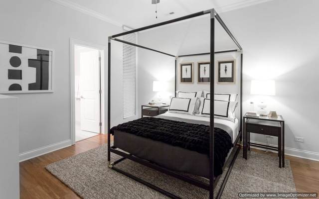 Undisclosed Address Chicago, IL 60607 - Photo 8 of 10 a bedroom with a bed lamp and a dresser