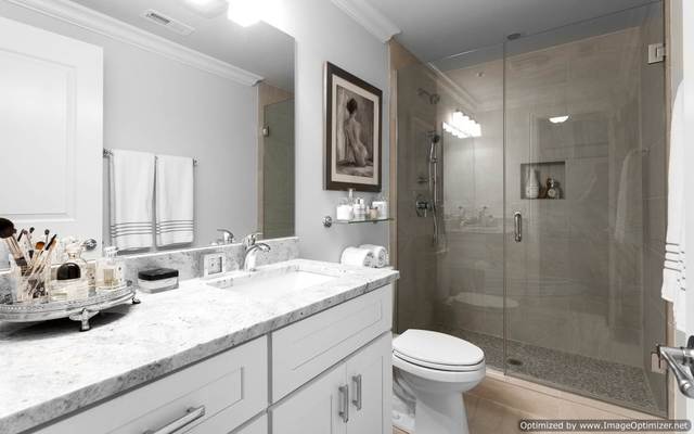 Undisclosed Address Chicago, IL 60607 - Photo 10 of 10 a bathroom with a granite countertop sink toilet and shower