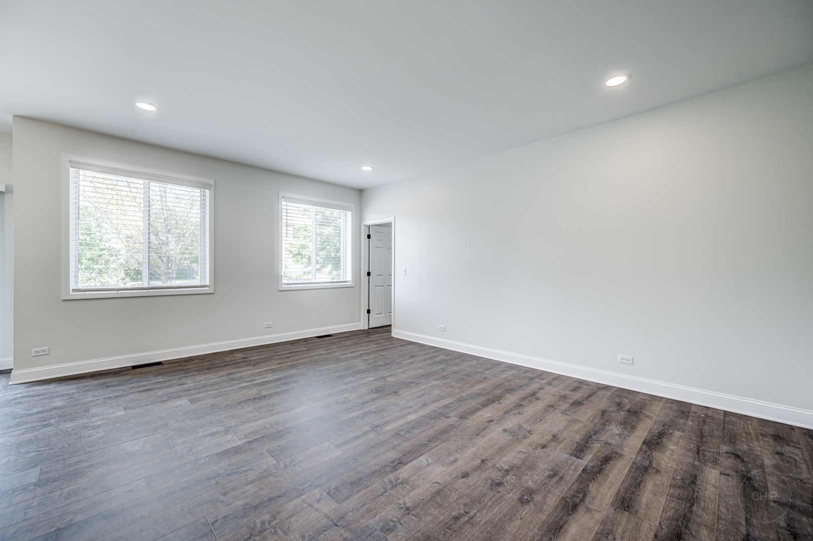 12948 Parterre Place Plainfield, IL 60585 - Photo 17 of 35 an empty room with wooden floor and windows
