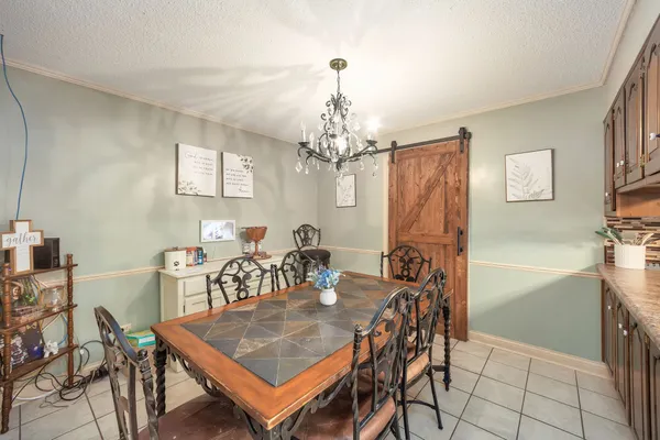 a view of a dining room with furniture and chandelier