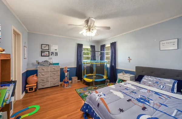 a bedroom with furniture and a wooden floor