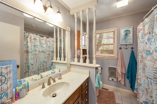 a bathroom with a sink mirror and a shower