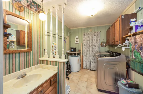 a bathroom with a sink a washer and dryer